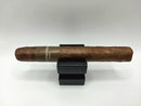 Cigar on a black stand with 'Chocolatier' branding against a white background - WD - Chocolate - Corona