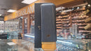 A Cohiba 2 cigar leather case in black and gold colors, displayed upright on a glass shelf in a store.

Details