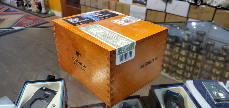 A box of Cohiba Siglo IV Cigars displayed on a table.