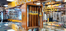 A box of Cohiba Siglo No. 2 cigars displayed in a retail setting with multiple shelves of cigars and smoking accessories in the background.

Details